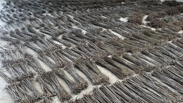 Powder coating hangers after stripping, laying on the floor ready for coating cycle